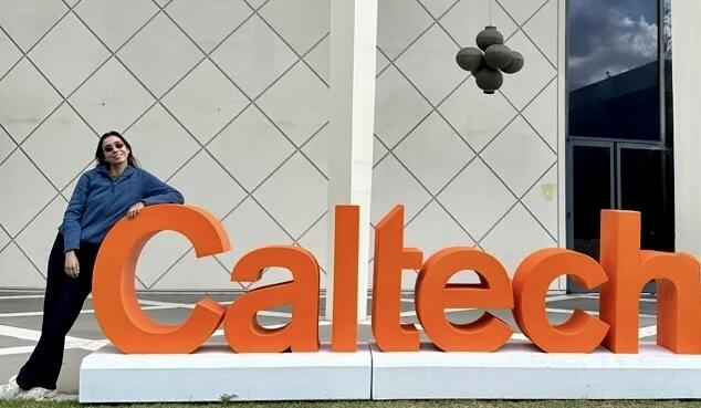 Andrea Loizidou beside the Caltech sign during the 2026 longevity event